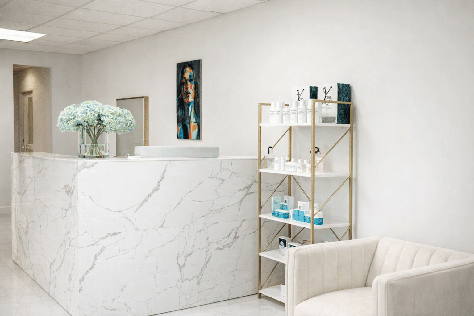 Reception desk with floral arrangement, artwork, and product display.