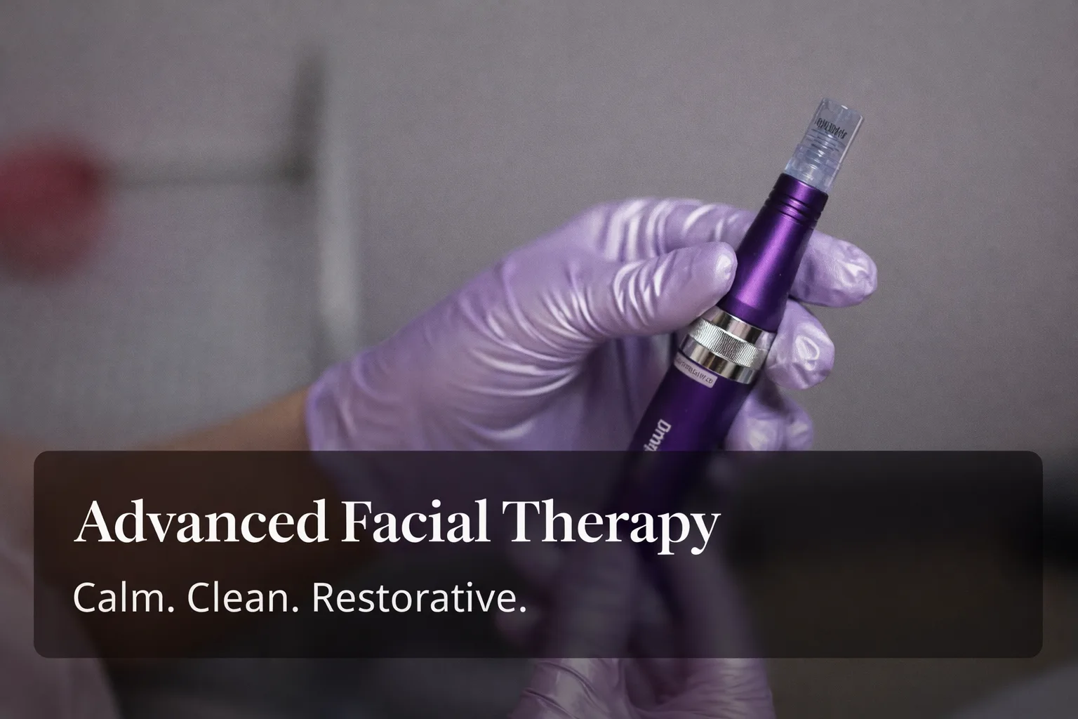 nn Gloved hand holding a purple facial therapy pen.