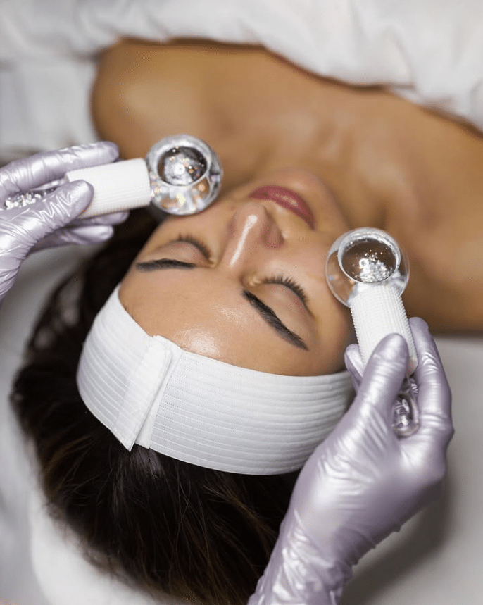 Facial cryo globes applied to a client's face at Skin Lounge Med Spa.