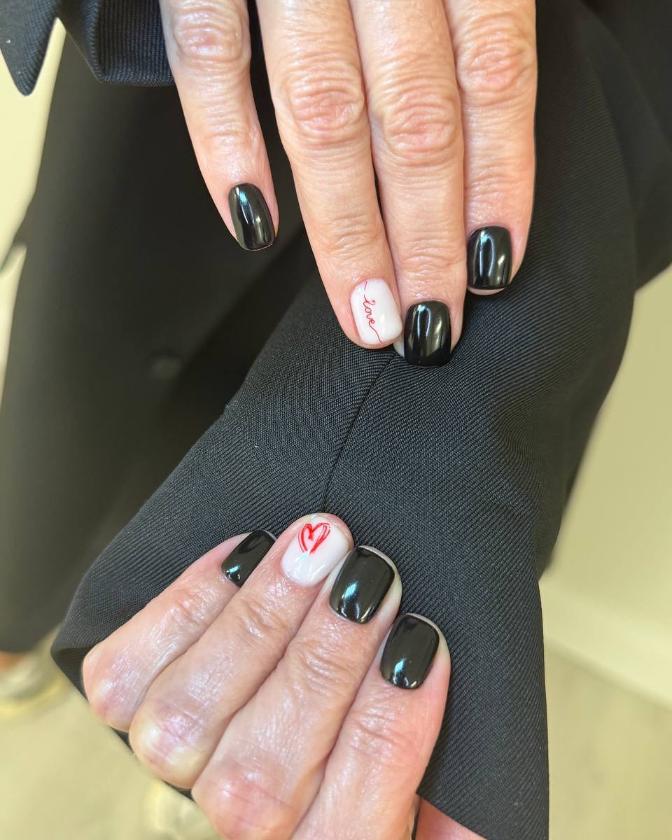 Black and white nails with red heart and "love" text.