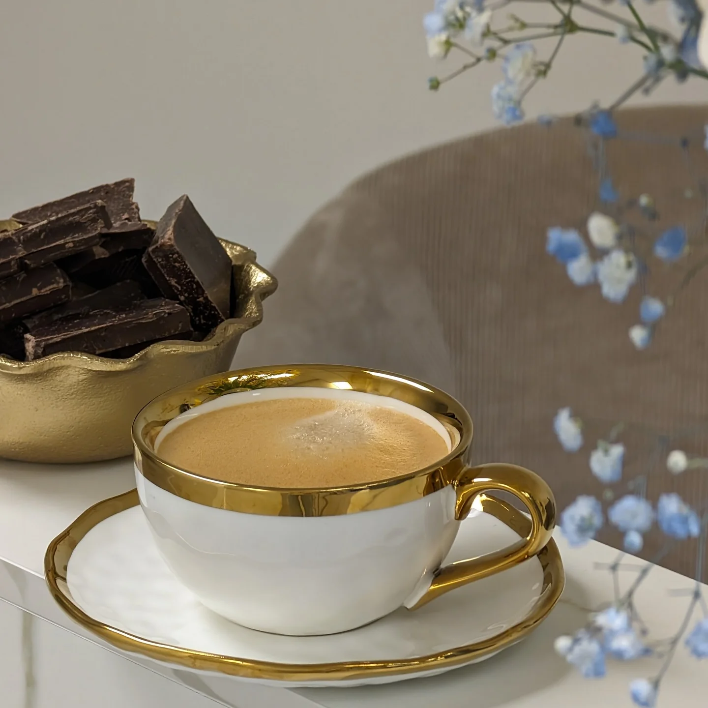 Coffee with chocolate and delicate blue flowers.