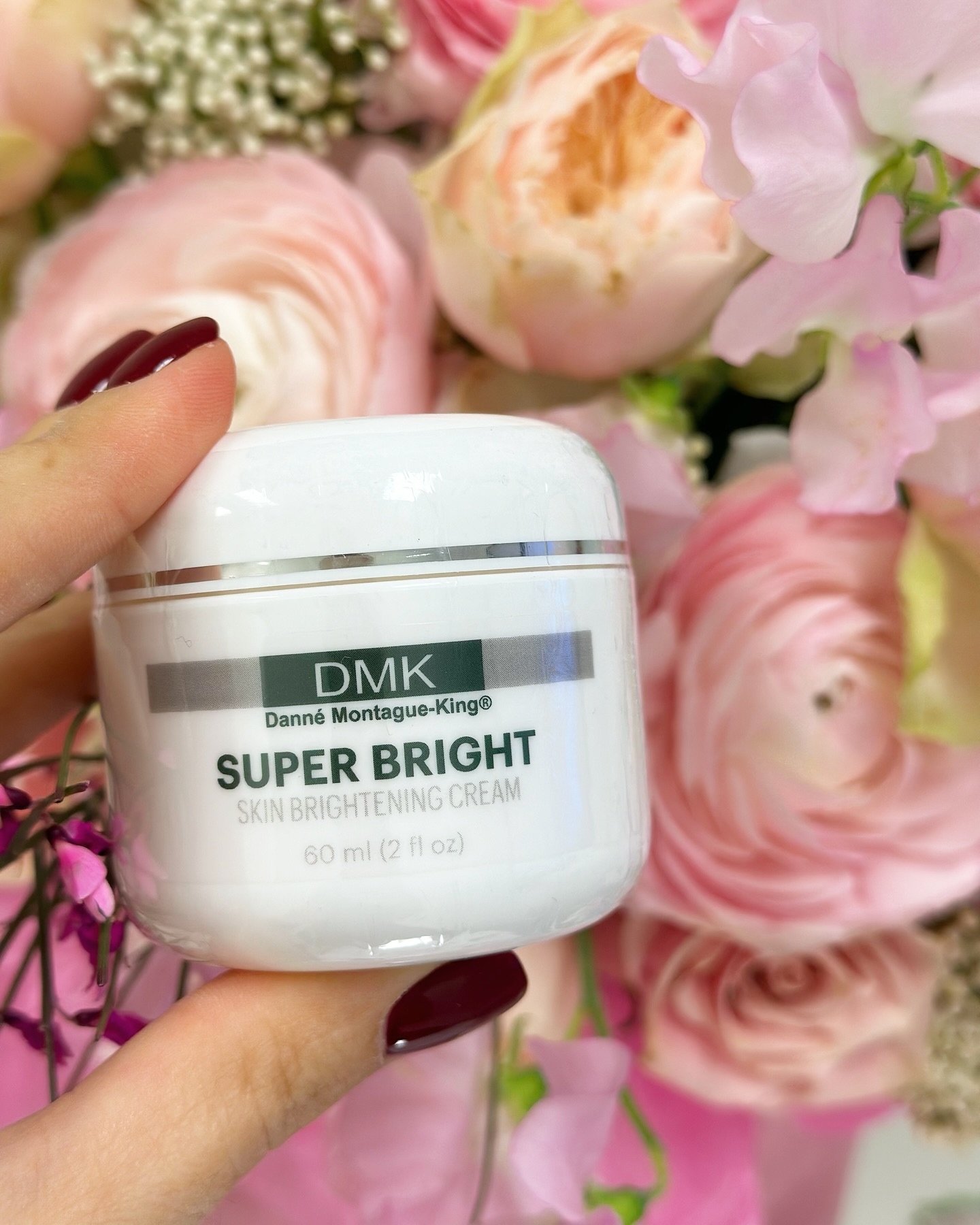 nn DMK Super Bright Skin Brightening Cream jar with flowers.
