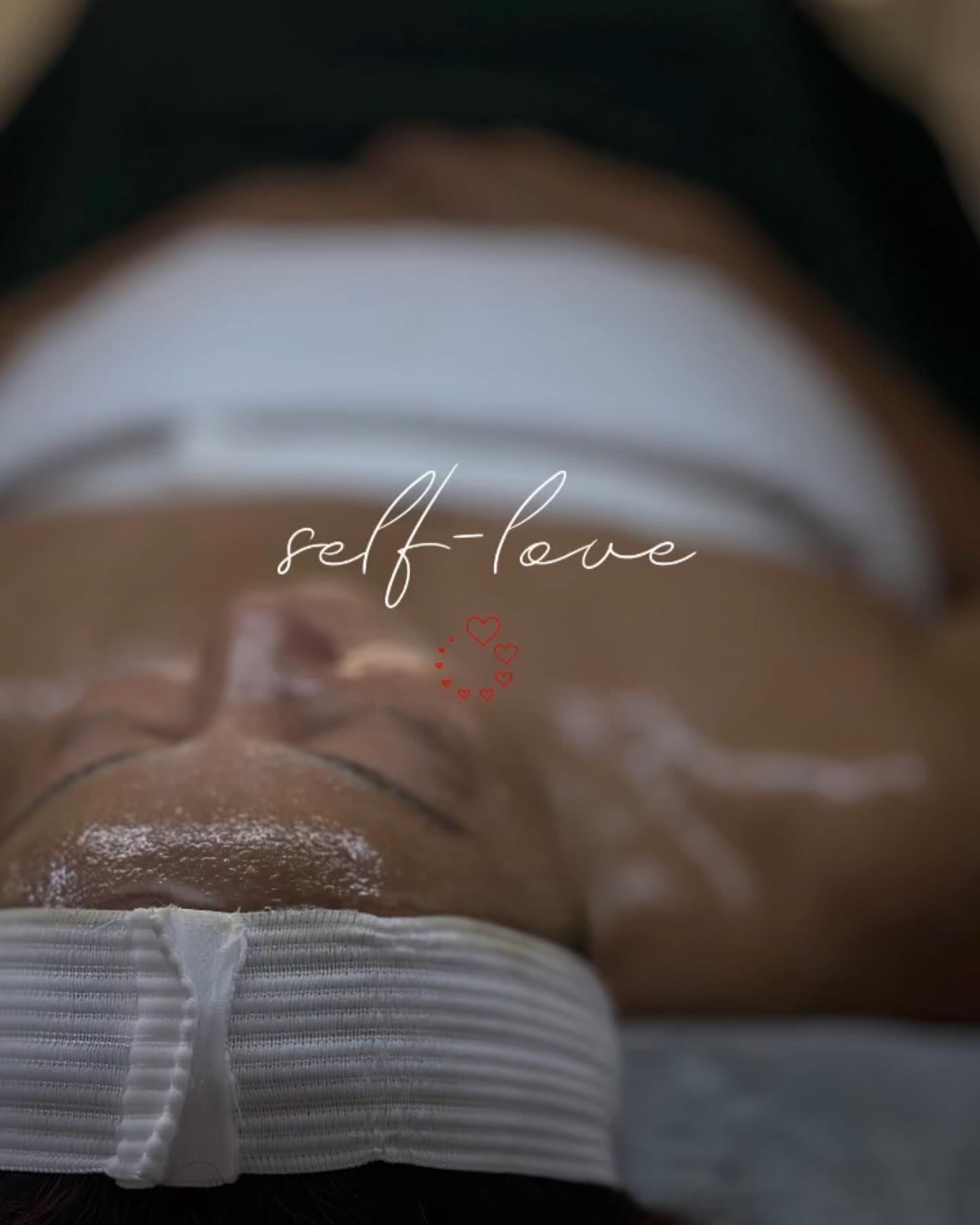 nn Close up of face with text "self-love" and hearts.