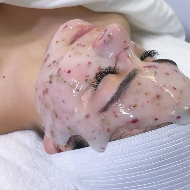 Close up of a face with a petal infused jelly mask at Skin Lounge Med Spa.