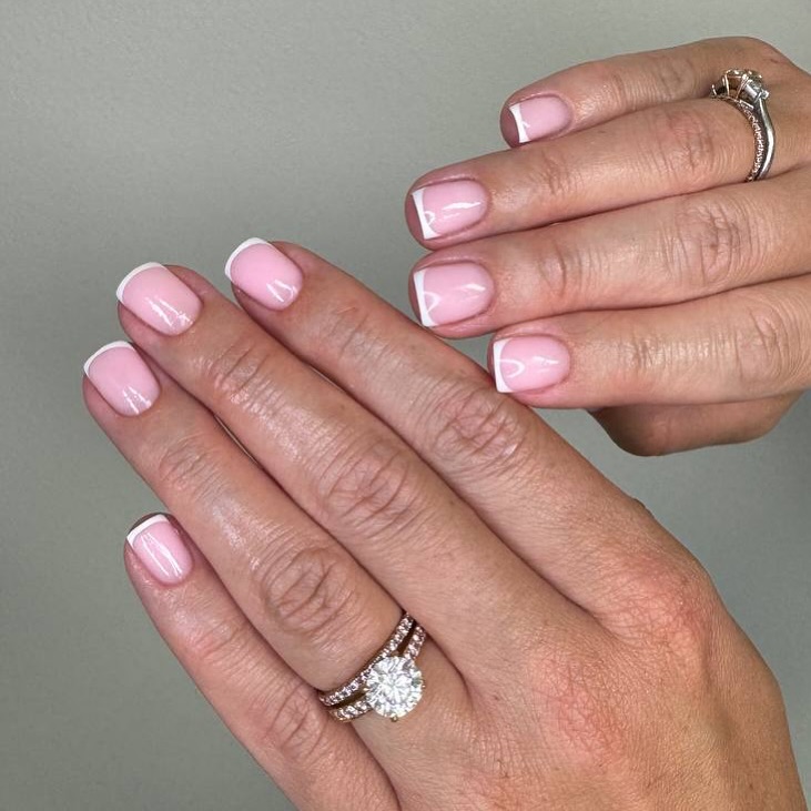 French tip nails with engagement rings.