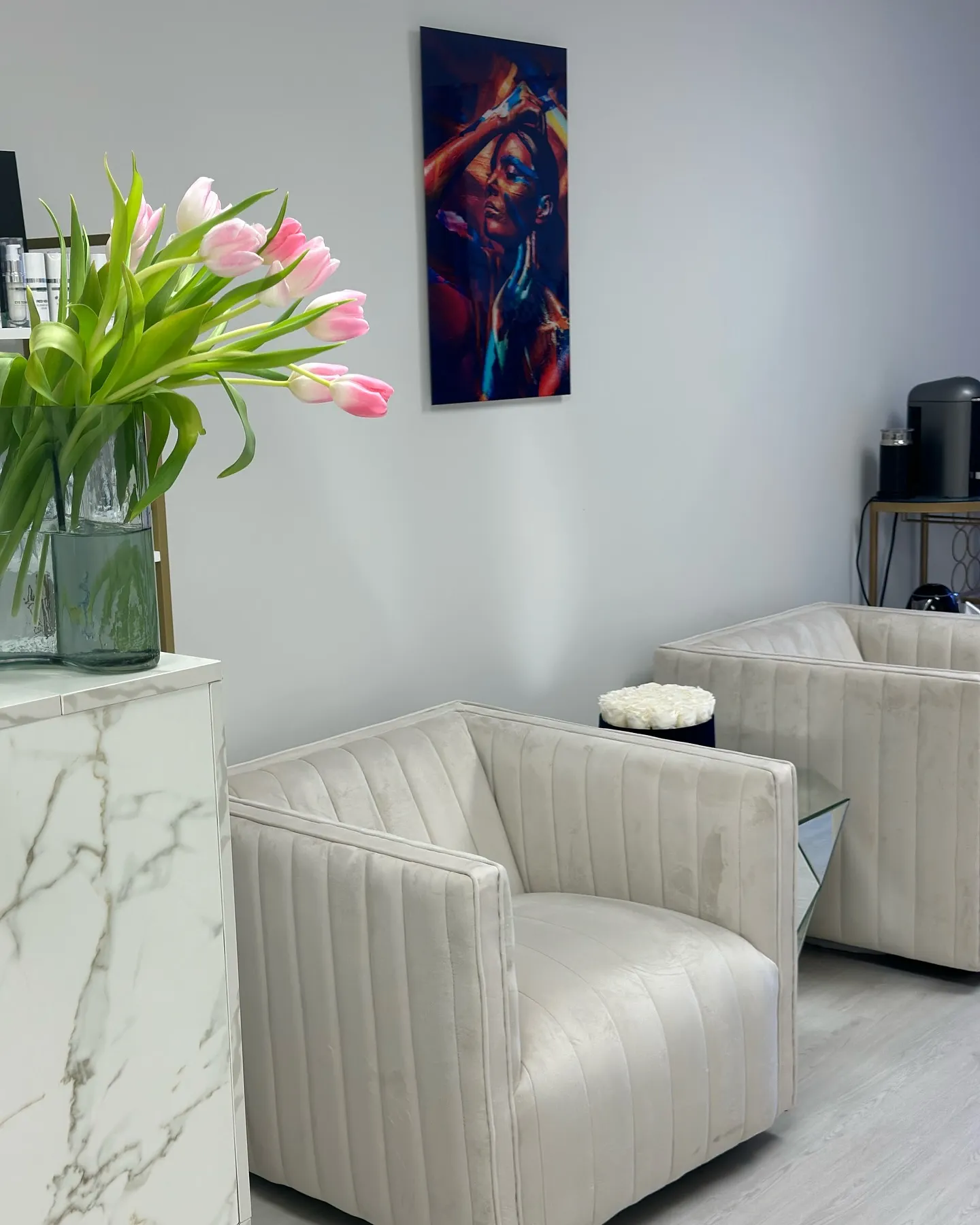 Skin Lounge Med Spa waiting area with tulips and modern art.